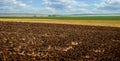 black soil fields in Ukraine. Agricultural rural landscape, colorful hills