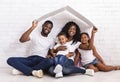 Beautiful Black Family Holding Cardboard Roof Dreaming Of New Home Royalty Free Stock Photo