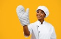 Beautiful Black Female Chef Wearing Oven Mitt Posing Over Yellow Background Royalty Free Stock Photo