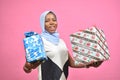 beautiful black girl holding gift boxes and presents smiling and feeling excited Royalty Free Stock Photo