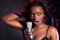 Beautiful black girl makes music singing on stage Royalty Free Stock Photo