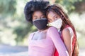 Beautiful black girls outside wearing cloth face masks. Masks are mandatory in many places to protect spread of