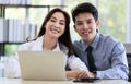 Beautiful black long hair Asian businesswoman and cute Asian businessman working together in office with intimate Royalty Free Stock Photo