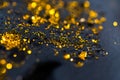 Beautiful black oil with glitter and colored bubbles in oil and watercolor. Golden sparkle particles. Macro oil ink bub