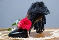 Black patent leather women`s shoes, pearls, rose and gloves