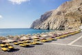 Beautiful black sand beach on Greek island of Santorini in Kamari village  sunny morning. Royalty Free Stock Photo