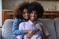 Beautiful Black teen girlfriend embracing boyfriend from behind Royalty Free Stock Photo