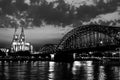 Beautiful black and white night landscape of the Cologne, Germany with gothic cathedral, railway and pedestrian Hohenzollern Royalty Free Stock Photo