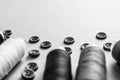 A beautiful black and white texture with many round buttons for sewing, needlework and coils of yarn. Copy space. Flat lay. the Royalty Free Stock Photo