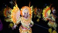 A beautiful black woman dressed in yellow costume with red accents with an Asian theme.