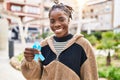 Beautiful black woman holding blue ribbon looking positive and happy standing and smiling with a confident smile showing teeth Royalty Free Stock Photo