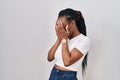 Beautiful black woman standing over isolated background with sad expression covering face with hands while crying Royalty Free Stock Photo