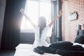 Beautiful black woman waking up in her bed, she is smiling and stretching Royalty Free Stock Photo