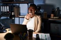 Beautiful black woman working at the office at night bored yawning tired covering mouth with hand Royalty Free Stock Photo