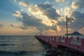 Beautiful blazing sunrises landscape with cloud and sun rays at Ao Prachuap bay with Saranwithi bridge stretching in to the sea