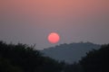 Beautiful blazing sunset landscape at over the meadow and orange sky above it. Amazing summer sunrise as a background Royalty Free Stock Photo