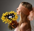 Beautiful blindfolded woman with bouquet of wild flowers cotton wheat spikelets Royalty Free Stock Photo