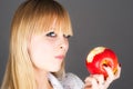 blond biting the apple