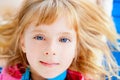 Beautiful blond blue eyes girl lying Royalty Free Stock Photo