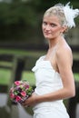 Beautiful blond bride holding bouquet Royalty Free Stock Photo