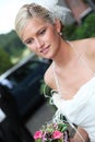 Beautiful blond bride holding bouquet Royalty Free Stock Photo