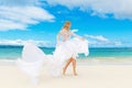 Beautiful blond bride in white wedding dress with big long train