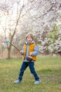 Beautiful blond child, boy, holding twig, braided whip made from pussy willow, traditional symbol of Czech Easter used for