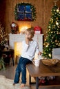 Beautiful blond child, young school boy, playing in a decorated home with knitted toys Royalty Free Stock Photo