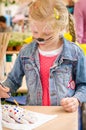 Girl with face painting in creative moment