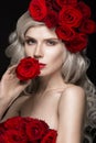 Beautiful blond girl in dress and hat with roses, classic makeup, curls, red lips. Beauty face. Royalty Free Stock Photo