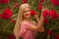 Beautiful blond girl in dress posing in summer park Royalty Free Stock Photo