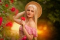 Beautiful blond girl in dress posing in summer park Royalty Free Stock Photo