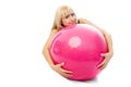 Beautiful blond girl embracing a fitness ball Royalty Free Stock Photo