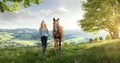 Beautiful blond girl with a horse in wonderful landscapes