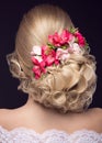 Beautiful blond girl in image of the bride with purple flowers on her head. Beauty face. Hairstyle back view Royalty Free Stock Photo