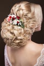 Beautiful blond girl in image of the bride with purple flowers on her head. Beauty face. Hairstyle back view Royalty Free Stock Photo