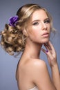 Beautiful blond girl in image of the bride with purple flowers on her head. Beauty face. Royalty Free Stock Photo