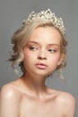 Beautiful blond girl in the image of a bride with a tiara in her hair. Royalty Free Stock Photo