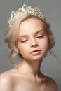 Beautiful blond girl in the image of a bride with a tiara in her hair. Royalty Free Stock Photo