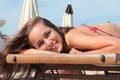 Beautiful blond girl lying smiling on the beach