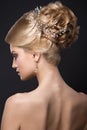 Beautiful blond girl with perfect skin, evening make-up, wedding hairstyle and accessories. Beauty face.