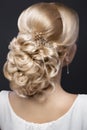 Beautiful blond girl with perfect skin, evening make-up, wedding hairstyle and accessories. Beauty face.