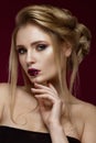 Beautiful blond girl with perfect skin, evening make-up, wedding hairstyle and accessories. Beauty face. Royalty Free Stock Photo