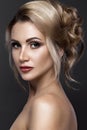 Beautiful blond girl with perfect skin, evening make-up, wedding hairstyle. Beauty face. Royalty Free Stock Photo