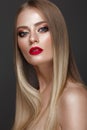 Beautiful blond girl with a perfectly smooth hair, classic make-up and red lips. Beauty face