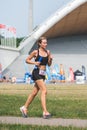 Beautiful blond girl in sport clothes running in the park