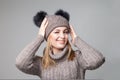 Beautiful blond girl wears winter pullover and hat Royalty Free Stock Photo