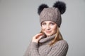 Beautiful blond girl wears winter pullover and hat Royalty Free Stock Photo