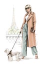 Beautiful blond hair girl with dog. Fashion girl with Eiffel Tower background. Stylish woman in coat in Paris city.