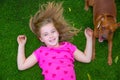 Beautiful blond kid children girl smiling lying on grass Royalty Free Stock Photo